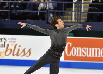 Jason Brown looks to the sky wearing a dark gray costume.
