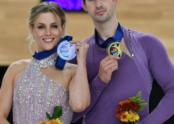 Madison Hubbell and Zachary Donohue pose with gold medal at U.S. International Classic