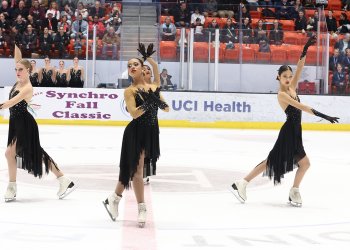 Dressed in all black dresses, Teams Elite junior performs their Swan Lake routine