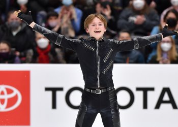 Ilia Malinin smiles in the ending pose of his short program.