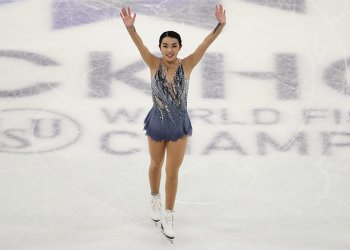 Karen Chen waves to the crowd with both arms after her short program performance at the World championships