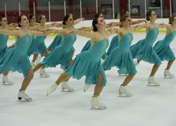 Adrian College in lines skating to the right.