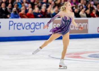 Amber Glenn, wearing a purple dress, skates to the right during the free skate at the U.S. Championships.