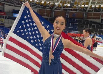 Evelyn Duffy extends the American flag after a recent competition. 
