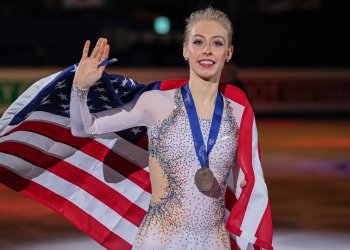 Bradie Tennell poses with the flag after winning bronze at Four Continents in 2020
