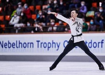 Vincent Zhou performs during Nebelhorn trophy with his arms outstretched