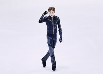 Ilia Malinin pumps his fist after the short program at the World Junior Championships.