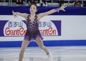 Dressed in purple, arms extended, Elyce Lin-Gracey glides across the ice at the 2024 Four Continents Championships.