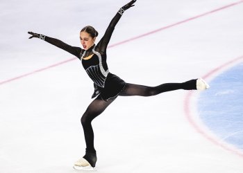 Sophie Joline Von Felten, dressed in a black and gray costume, shows her emotion with arms and legs extended.