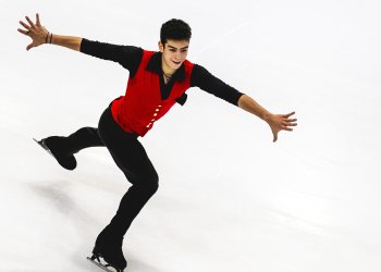 Dressed in a red top and black sleeves and black pants, Jacob Sanchez displays his skating skills with arms extended