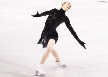 Dressed in all black, including gloves, Bradie Tennell lays back with arms extended at the Shanghai Trophy