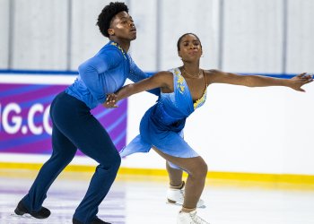 Anaelle Kouevi and Yann Homawoo skate in hold at JGP Turkey. She wears an ombre blue dress with yellow detail on teh shoulders while he wears a blue top of the same color and navy pants.