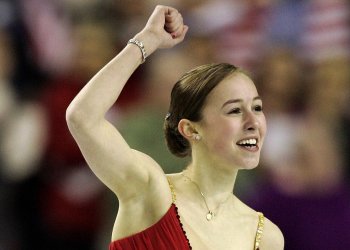 Kimmie Meissner raises her hand in triumph after performing her free skate at the 2006 World Championships.