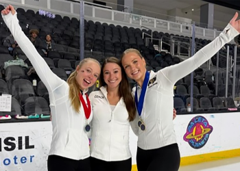 CU Figure Skating team members Emma Cumming, coach Courtney Wetterich and Kendall Taulbee, dressed in white tops and black pants, celebrate after their qualification to the National Intercollegiate Final.