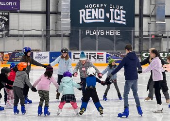 A group of young skaters form a circle to work on their skating skills at Reno Ice.