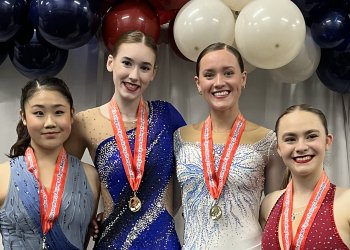 Kendall Erne, second from left, wearing a violet-colored costume, stands on the podium as the 2025 U.S. Collegiate Figure Skating Championships. Standing to left of her is silver medalist Clare Seo, to her right is Maryn Pierce and far right is Wren Warne-Jacobsen