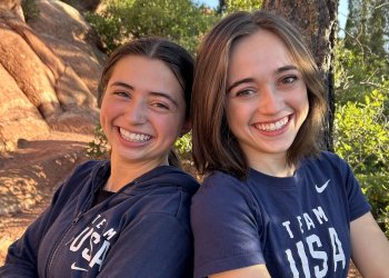 Dressed in their blue Team USA shirts, Olivia and Isabella Flores take a photo in the nearby mountains of Colorado Springs.