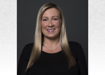 Headshot of Isabelle McLemore. She is an older woman with long blonde hair wearing a long sleeve black top and a pearl necklace. 