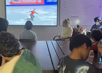 Students watch Jacob Sanchez skate on a big screen