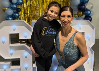 Dressed in black, Elora stands next to her mother, Naomi Lang, who just competed as member of the IceDenettes. 