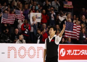 Nathan Chen wave to the crowd after his short program at the U.S. Figure Skating Championships