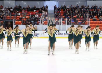 Teams Elite performs their skate charmer-themed free skate in matching green and gold skating costumes at Budapest Cup 2024. 