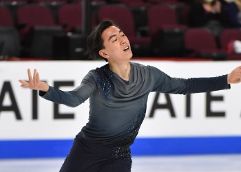 Vincent Zhou skates with his arms out at 2021 Skate America