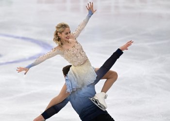 Alexa Knierim sits on Brandon Frazier's shoulders while performing a lift element at Worlds in 2022.