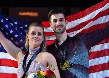 Madison Hubbell and Zachary Donohue hold up the American flag. 