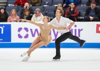 Neset and Markelov compete in the junior free dance at the 2024 Prevagen U.S. Figure Skating Championships. Neset is wearing a long sleeve nude colored skating costume with silver jewels down the front. Markelov is wearing a white button down shirt and black pants, Markelov skated behind Neset holding one hand on her waist and the other holding her left arm