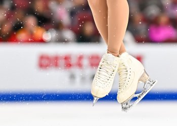 Close up of an athlete's skates during a jump. 